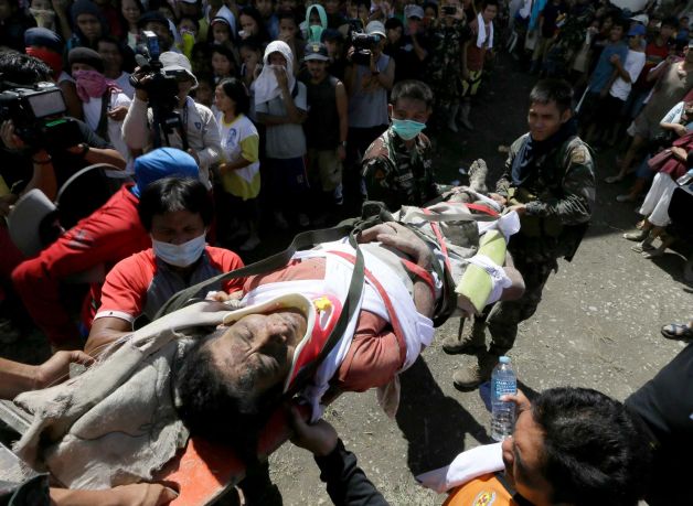 A survivor of Tuesday's devastating typhoon is carried into a makeshift clinic after being rescued Thursday, Dec. 6, 2012, in New Bataan township, Compostela Valley in the southern Philippines.  The powerful typhoon that washed away emergency shelters, a military camp and possibly entire families in the southern Philippines has killed hundreds of people with nearly 400 missing, authorities said Thursday. Photo: Bullit Marquez / AP